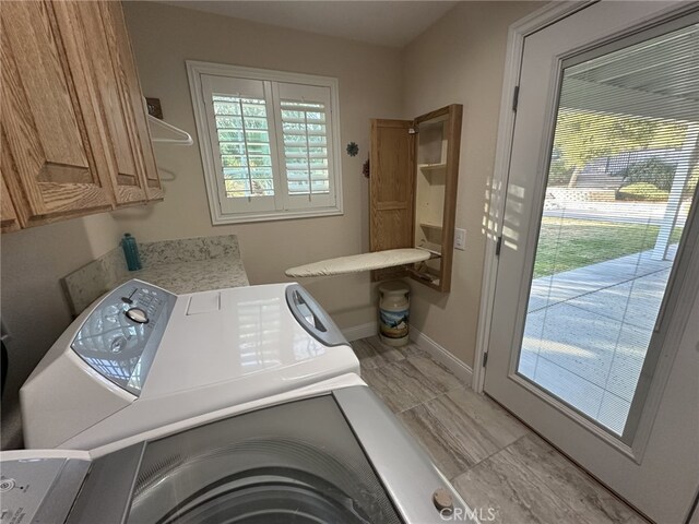 16232 Ridge View Dr, Apple Valley, CA 92307 - clothes washing area featuring cabinet space, baseboards, and separate washer and dryer