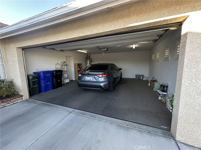 garage with secured water heater and a garage door opener