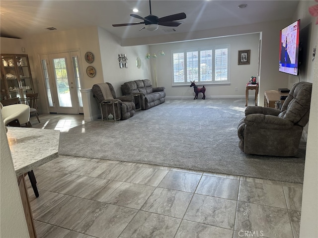 living room featuring light carpet, a wealth of natural light, and ceiling fan