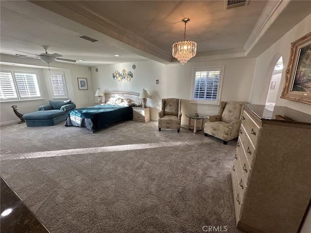 bedroom featuring an inviting chandelier, ornamental molding, a tray ceiling, and carpet flooring