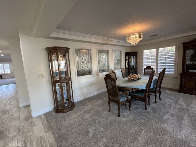 carpeted dining room with a notable chandelier, plenty of natural light, and crown molding