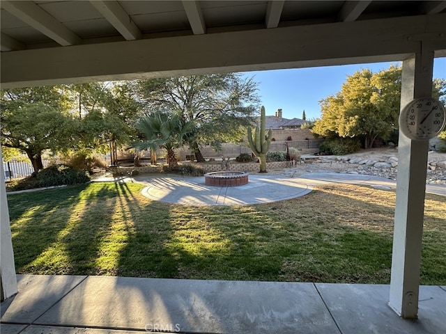 view of yard featuring an outdoor fire pit and a patio