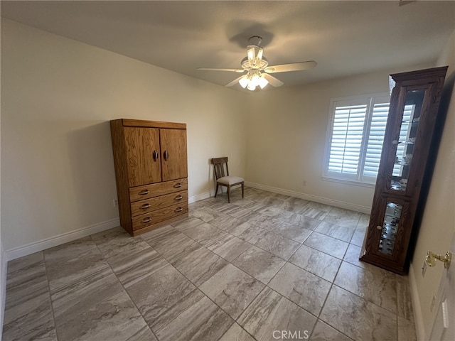 16232 Ridge View Dr, Apple Valley, CA 92307 - empty room featuring light marble finish floors, baseboards, and a ceiling fan