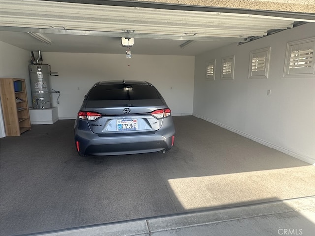 16232 Ridge View Dr, Apple Valley, CA 92307 - garage with strapped water heater, a garage door opener, and baseboards
