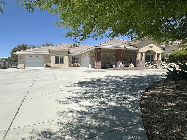 16232 Ridge View Dr, Apple Valley, CA 92307 - view of front of house featuring a garage, stucco siding, driveway, a tile roof, and fence