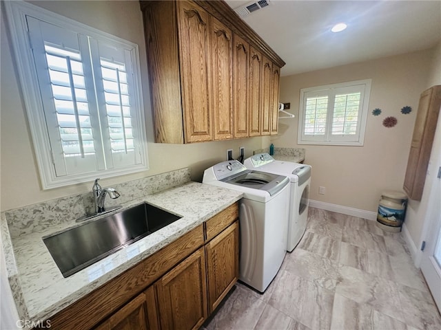 16232 Ridge View Dr, Apple Valley, CA 92307 - laundry area featuring cabinet space, washing machine and clothes dryer, light marble finish flooring, and baseboards