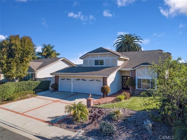 view of front of property with a front yard and a garage