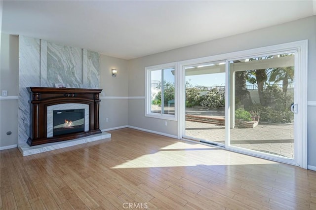 unfurnished living room with a fireplace and light hardwood / wood-style floors