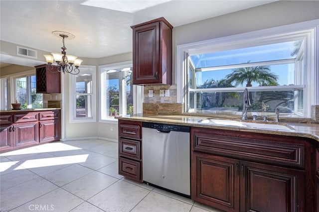 kitchen with sink, an inviting chandelier, dishwasher, light tile patterned floors, and tasteful backsplash