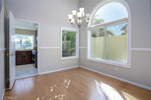 dining area with light hardwood / wood-style floors and a chandelier