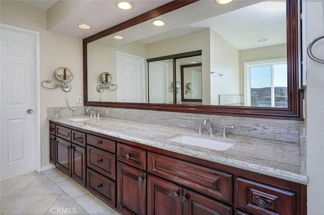 bathroom featuring tile patterned flooring and vanity