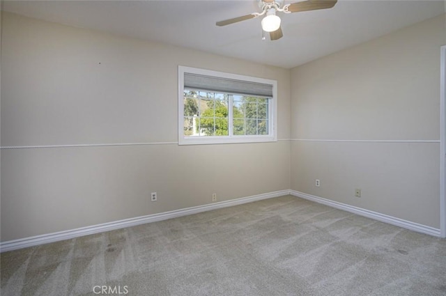 spare room featuring ceiling fan and light carpet