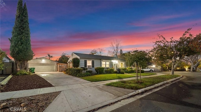 single story home featuring a yard and a garage