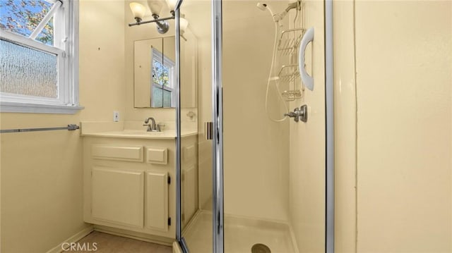 bathroom with vanity and a shower with door