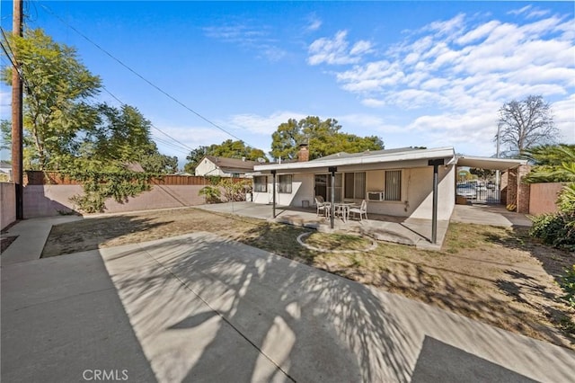 rear view of property featuring a patio