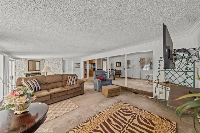 living room with a textured ceiling, crown molding, and carpet