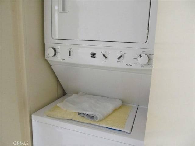 laundry area featuring stacked washer and dryer