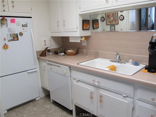 kitchen with white cabinets, white appliances, and sink