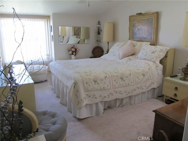 bedroom featuring light colored carpet