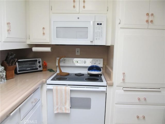 kitchen with white appliances and white cabinetry