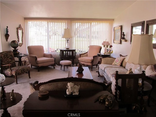 living room with lofted ceiling and light carpet