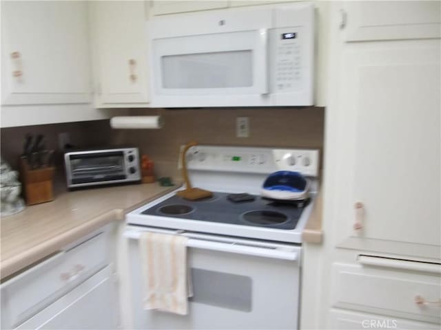 kitchen with white cabinets and white appliances