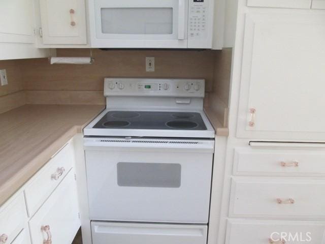 1351 Weeburn Rd Unit M4-74G, Seal Beach, CA 90740 - kitchen featuring white appliances, white cabinetry, light countertops, and backsplash
