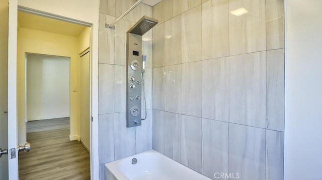 bathroom featuring shower / bath combination and hardwood / wood-style floors