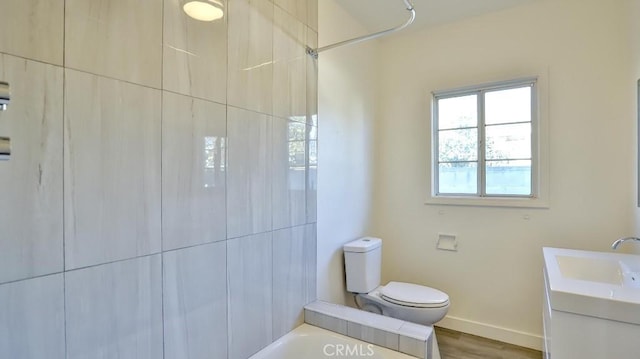 bathroom with toilet, wood-type flooring, and vanity