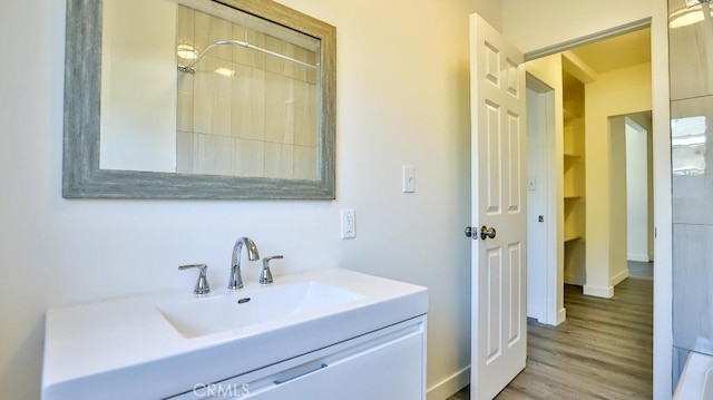 bathroom featuring vanity, hardwood / wood-style flooring, and walk in shower