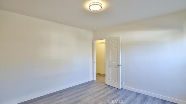 spare room featuring light wood-type flooring