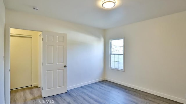 empty room with light hardwood / wood-style flooring