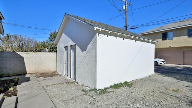 view of home's exterior with an outbuilding