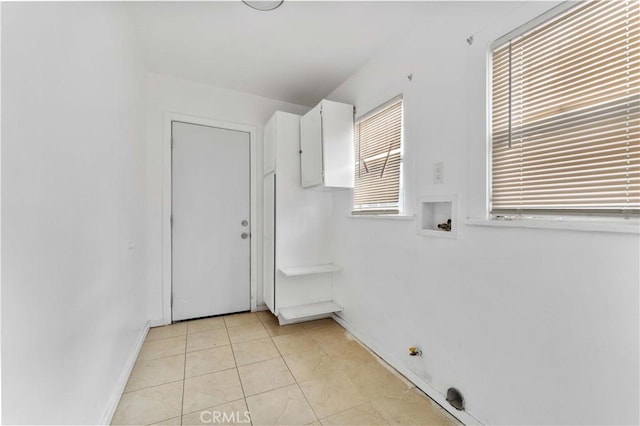 washroom featuring washer hookup and light tile patterned flooring