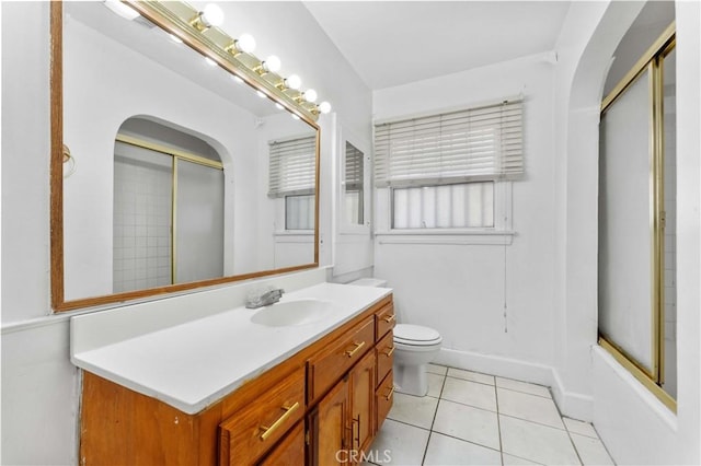 full bathroom with toilet, vanity, tile patterned flooring, and enclosed tub / shower combo