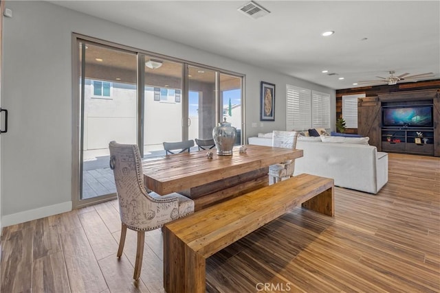 dining space with light hardwood / wood-style flooring and ceiling fan