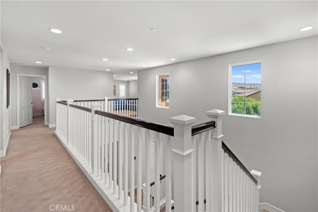 hall featuring light colored carpet