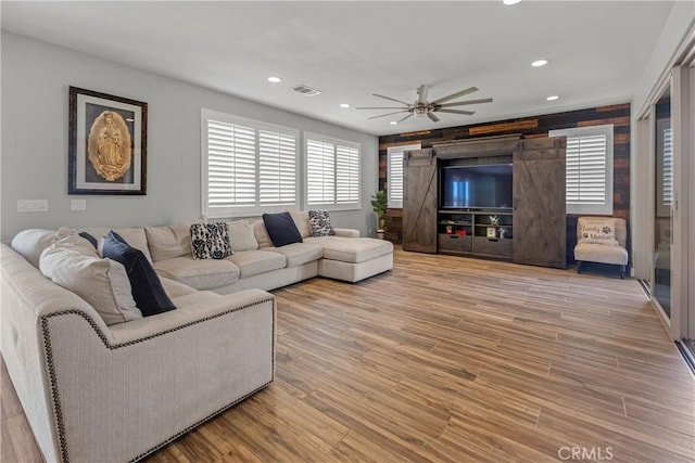 living room with ceiling fan and light hardwood / wood-style floors