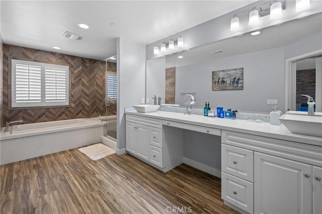 bathroom with hardwood / wood-style flooring, vanity, and separate shower and tub