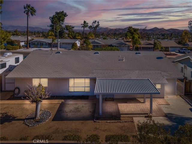 back house at dusk featuring a mountain view