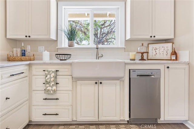 kitchen with white cabinets, dishwasher, and sink