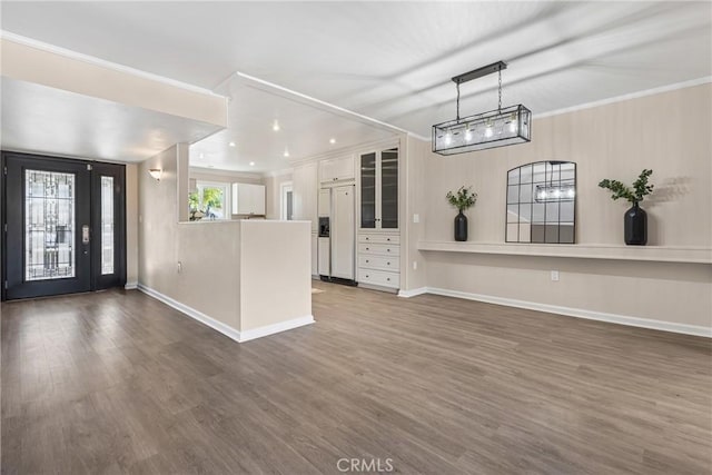 interior space with white cabinets, dark wood-type flooring, and ornamental molding