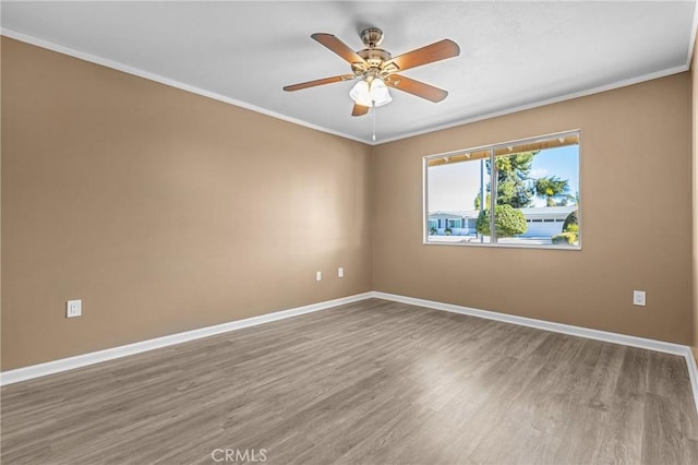 empty room featuring wood-type flooring, ceiling fan, and crown molding