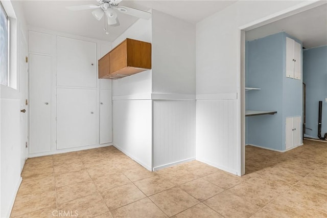 tiled empty room featuring ceiling fan