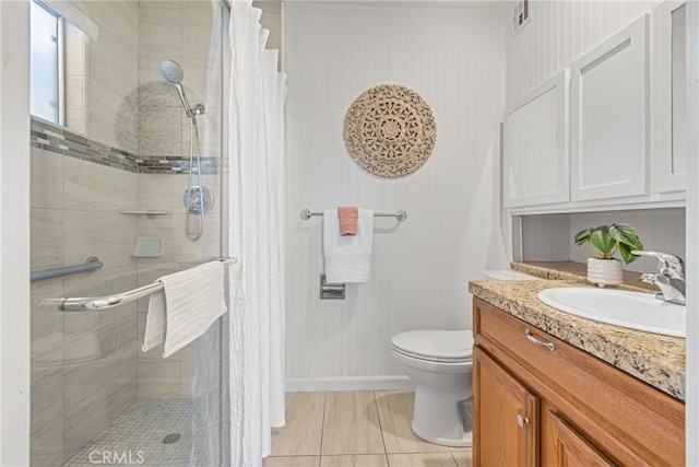 bathroom featuring curtained shower, tile patterned floors, vanity, and toilet