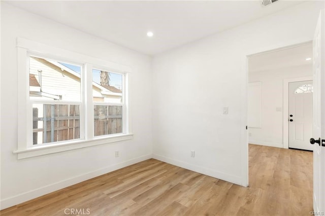 unfurnished room with light hardwood / wood-style flooring