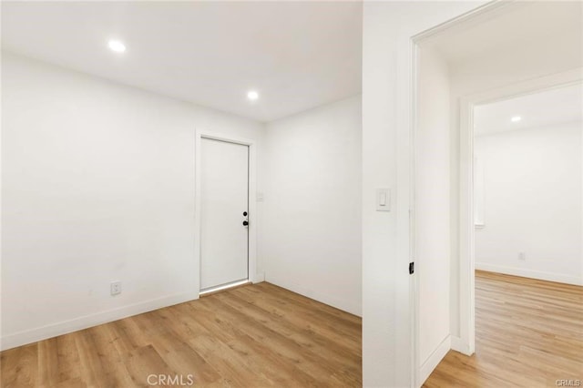 empty room with light hardwood / wood-style flooring