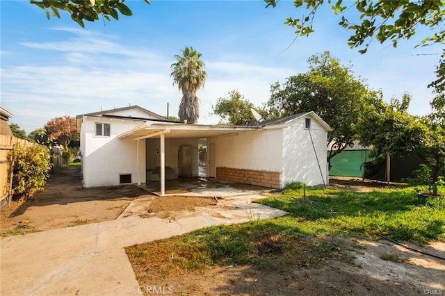 back of house with a carport