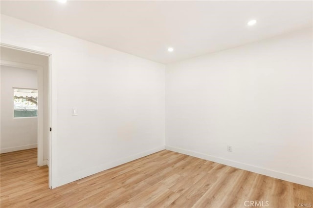 spare room featuring light hardwood / wood-style floors