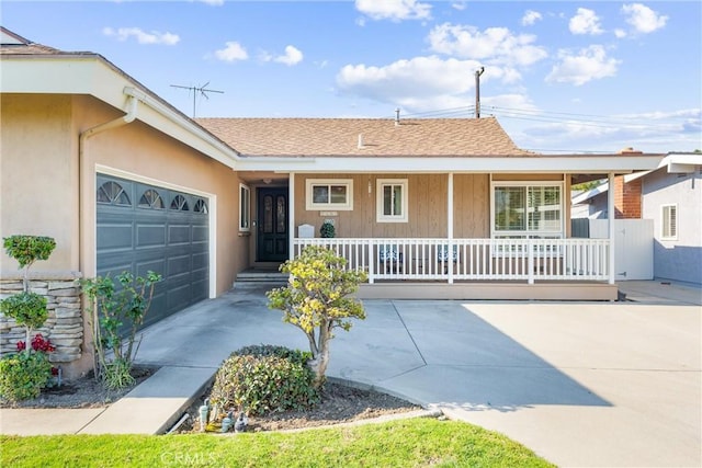 ranch-style house featuring a porch and a garage